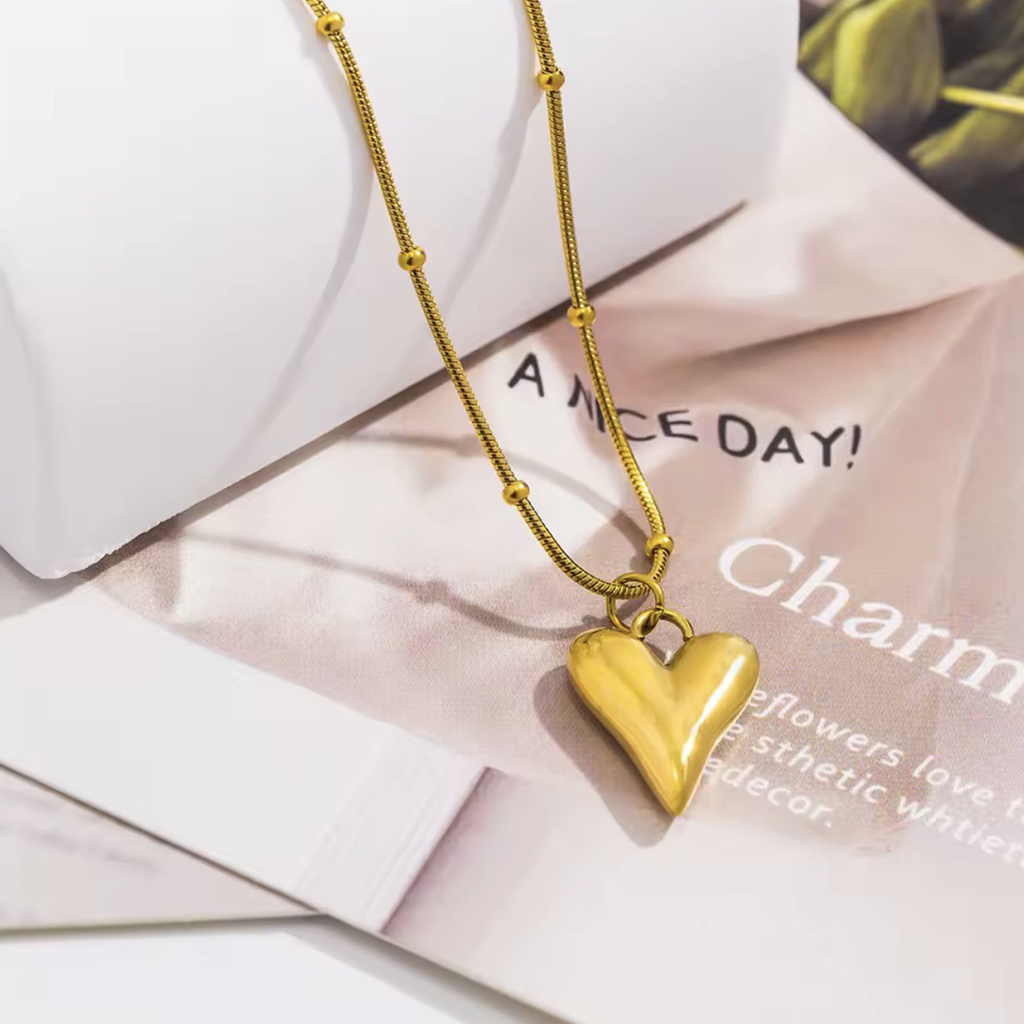 Close-up of The Amara smooth heart pendant crafted from 18K PVD gold plated stainless stee