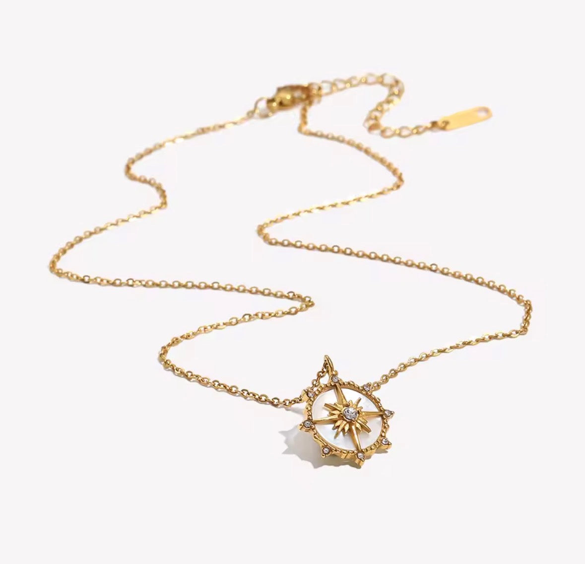 Shop The Polaris Necklace – an 18K PVD gold-plated stainless steel compass pendant with sparkling cubic zirconia. Waterproof, tarnish-resistant and hypoallergenic.