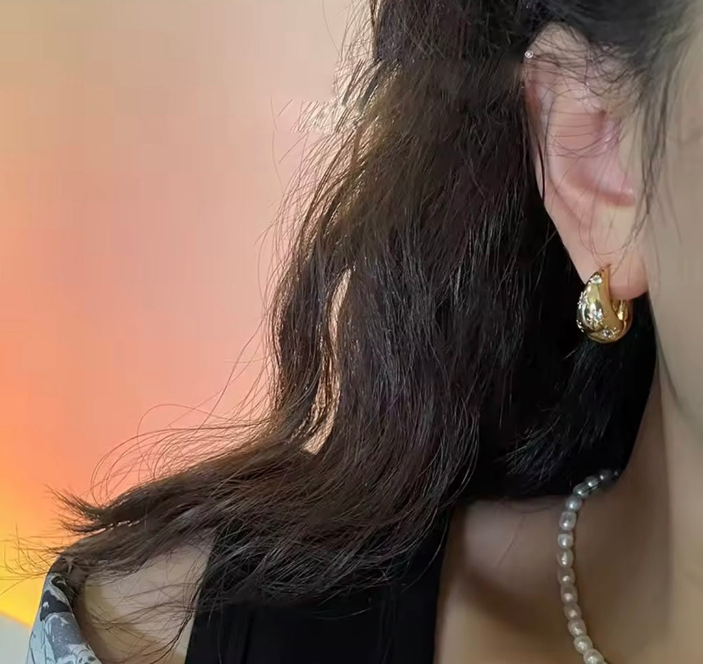 model Wearing The Astra Chunky Gold Star Hoop Earrings