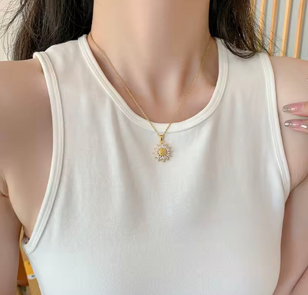 Shop The Helia Necklace, a waterproof stainless steel sunflower pendant necklace with 18K gold plating and sparkling crystal detail. Elegant and gift-worthy.