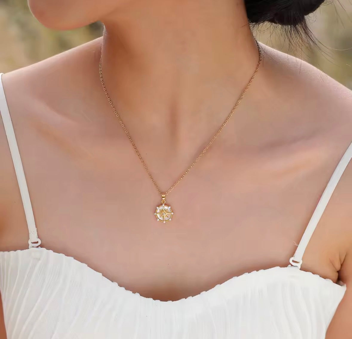 Shop The Polaris Necklace – an 18K PVD gold-plated stainless steel compass pendant with sparkling cubic zirconia. Waterproof, tarnish-resistant and hypoallergenic.