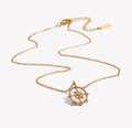 The Polaris waterproof gold compass necklace with cubic zirconia pendant.