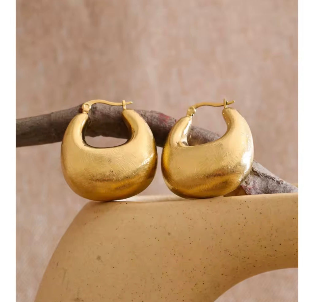 The Savara chunky gold hoop earrings displayed on a neutral background