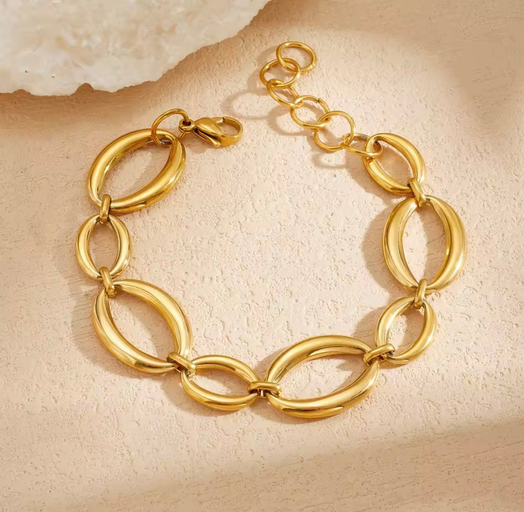 Gold statement bracelet with interlocking oval links and adjustable chain